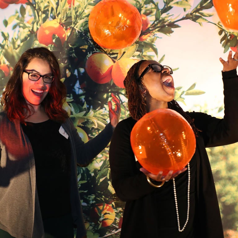 women posing with oranges